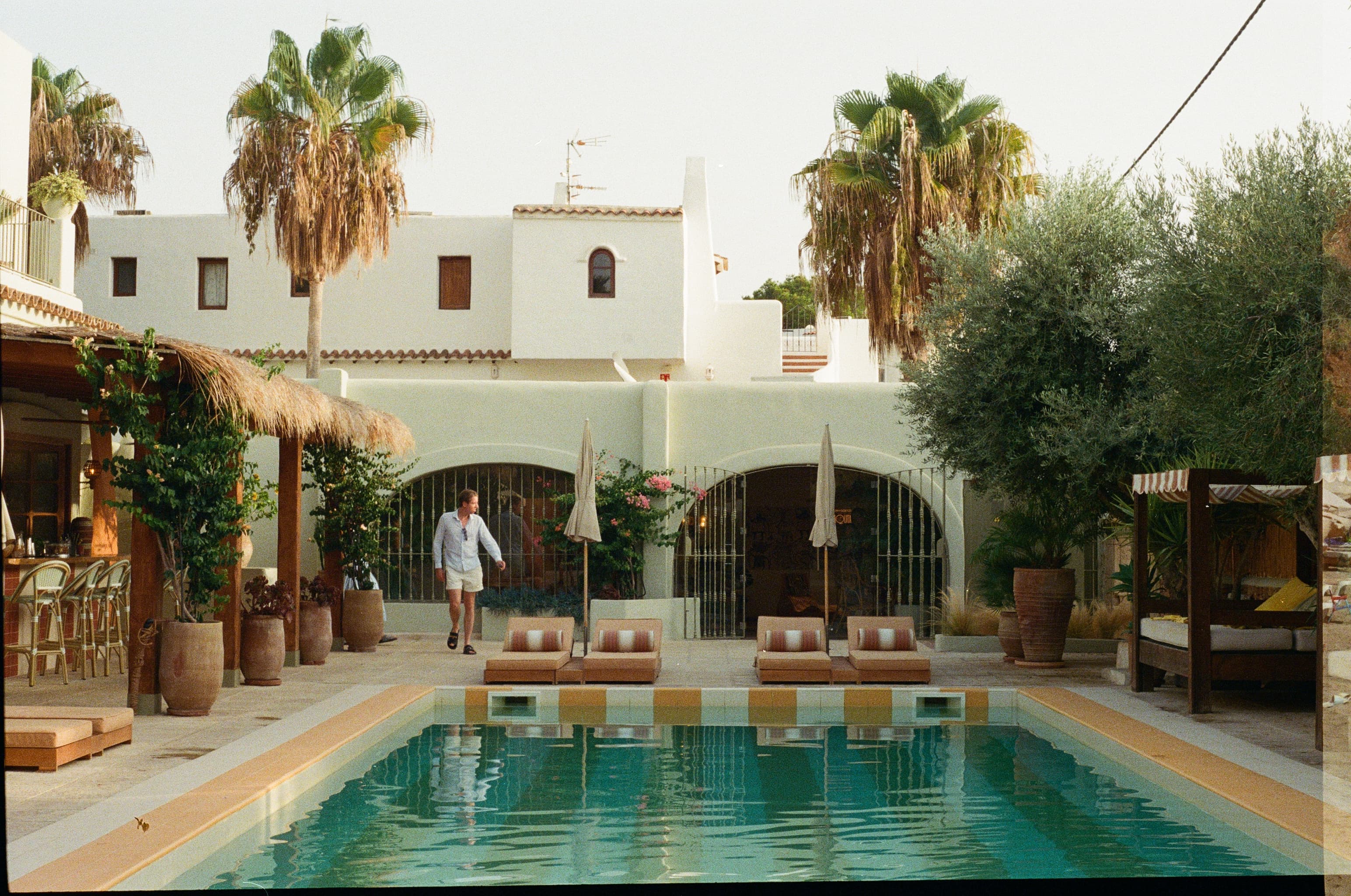 A whitewashed Mediterranean villa and pool